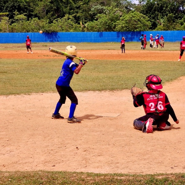 A youth baseball batter and catcher at the plate